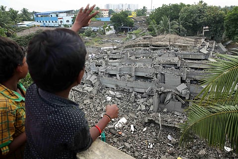 A boy explaining to his friend how was demolished at Moulivakkam in Chennai  on Thursday.(Sunish P Surendran | EPS)