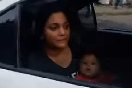 Woman sitting in the rear seat and her seven-month-old baby. (Photo | YouTube screen grab)