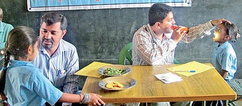Dr M P Varsha (left) and a member of the NGO during a health check-up and medicine distribution session at a govt school