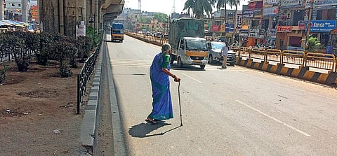 A senior citizen struggles to cross Tumkuru Main Road