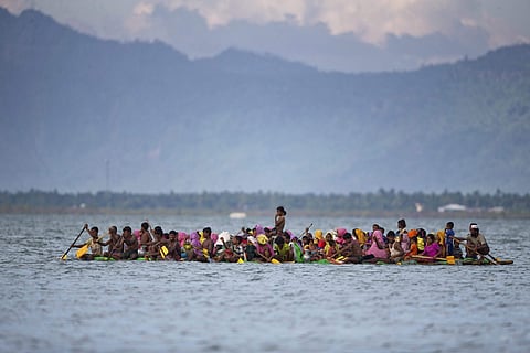 Rohingya Muslims on a raft made with plastic containers cross over the Naf River from Myanmar into Bangladesh near Shah Porir Dwip, Bangladesh. (AP Photo)
