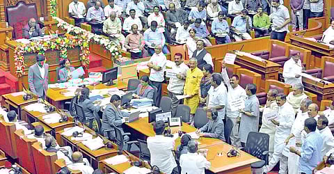 BJP legislators show placards demanding the resignation of minister KJ George on the first day of the Legislative Council’s winter session in Belagavi on Monday | Rajesh Sadare