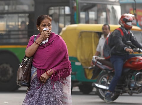 A woman covers her face with a cloth on a smoggy morning in New Delhi, India, November 14, 2017.  | Reuters