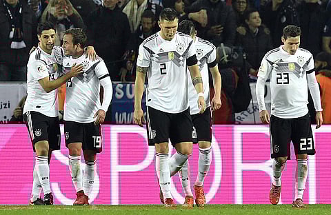 Germany's last minute scorer Lars Stindl, left, and his temmate Germany's Mario Goetze, 2nd left, celebrate their side's 2nd goal in the match against France. | AP