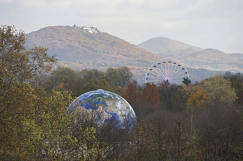 A globe and a Ferris Wheel stand in the forest near Bonn, Germany, Monday, Nov. 13, 2017. The UN Climate Conference takes place in Bonn, Germany till Nov. 17, 2017. (Photo | Associated Press)