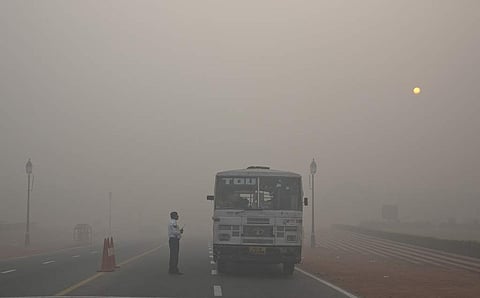 A New Delhi traffic policeman talks to a bus driver at an intersection. (Photo | AP)
