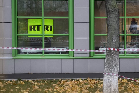 In this file photo taken dated Friday, Oct. 27, 2017, Russian state-owned television station RT logo is seen at the window of the company's office in Moscow, Russia. (Associated Press)