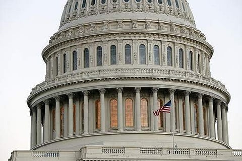 The American flag flies in front of the U.S. Capitol dome at sunset on Capitol Hill in Washington.  (Photo |AP)