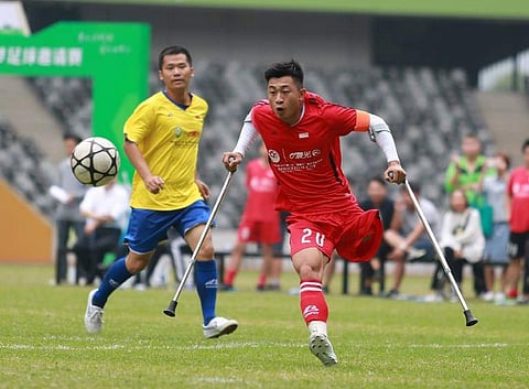 In this picture taken on November 12, 2017, He Yiyi kicks the ball during a football match with a local team in Guangzhou, Guangdong province. | AFP