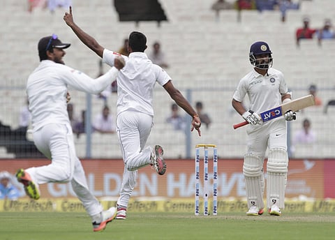 Sri Lanka's captain Dinesh Chandimal, left, and Dasun Shanaka, center, celebrate the dismissal of India's Ajinkya Rahane| AP
