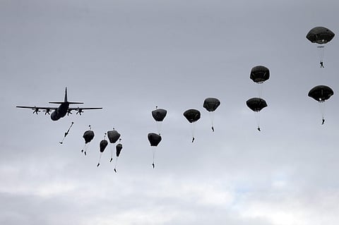 Members of the U.S. Army 173rd Airborne Brigade and Serbian Army parachutists jump from a US Air Force C-130 transport aircraft during a bilateral Serbian and U.S. airborne exercise at Lisicji jarak airport, some 15 kilometers (10 miles) north of Belgrade