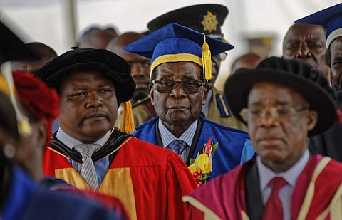 Zimbabwe's President Robert Mugabe, center, arrives to preside over a student graduation ceremony at Zimbabwe Open University on the outskirts of Harare, Zimbabwe Friday, Nov. 17, 2017. (AP Photo)