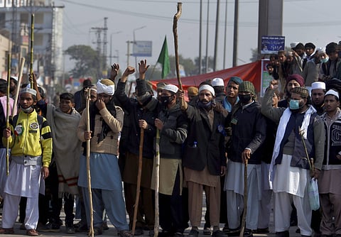slamabad Supporters of Pakistani radical religious party hold sticks while chanting slogans close to the site of sit-in protest at an intersection of Islamabad Pakistan Saturday Nov. 18 2017. (PTI)