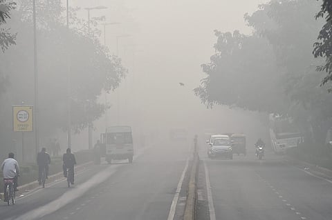 People commute through dense smog in New Delhi. | PTI