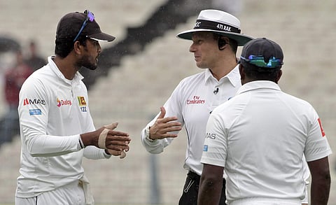 Umpire Richard Kettleborough interacts with Dinesh Chandimal and Rangana Herath of Sri Lanka | AP