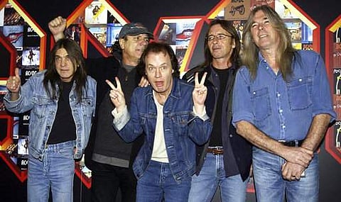 FILE - A March 3, 2003 file photo of from left: Malcolm Young, Brian Johnson, Angus Young, Phil Rudd and Cliff Williams from AC/DC posing for photographers at the Apollo Hammersmith in London. The band has announced, Saturday Nov. 18, 2017, that 64-year-o