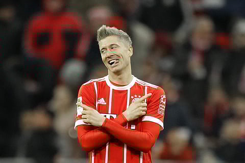 Bayern Munich's Robert Lewandowski celebrates after scoring his side's third goal during the Bundesliga match against FC Augsburg. | AP