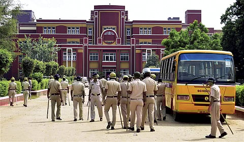 On September 8, the body of the class II student Pradyuman was found inside the toilet of the school, with his throat slit. In  image: Police outside the Ryan International School in Gurugram where Pradyuman was found dead. (File | PTI)