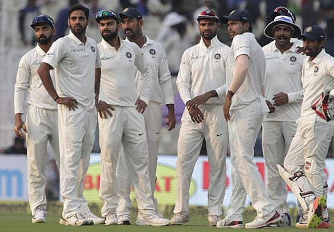 Indian players watch the replay of Sri Lanka's Niroshan Dickwella's dismissal during the fifth day of their first test cricket match in Kolkata, India, Monday, Nov. 20, 2017. | AP