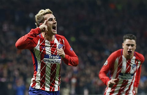 Atletico's Antoine Griezmann celebrates scoring the opening goal during a Champions League group C soccer match against Roma. | AP