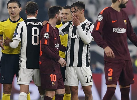 Juventus' Paulo Dybala, 2nd right, talks to Barcelona's Lionel Messi at the end of the Champions League group D soccer match. | AP