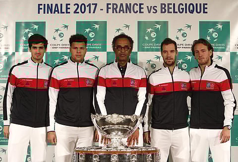 French captian Yannick Noah, center, and players Pierre-Hugues Herbert, left, Jo-Wilfried Tsonga, Richard Gasquet, second right, and Lucas Pouille pose with the trophy during the draw for the Davis Cup final. | AP