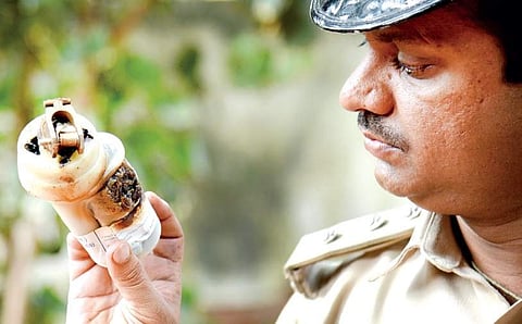 A Fire officer examines a used tear gas shell near Mysore Road on Friday | Nagaraja Gadekal
