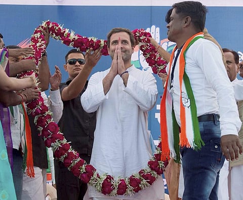 Congress Vice President Rahul Gandhi being garlanded at a public meeting in Bayad in Aravalli district of Gujarat on Saturday. | PTI
