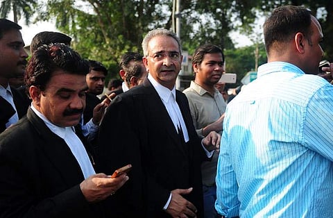 Lawyer Tanveer Ahmed Mir (C) leaves Allahabad high court after the acquital of his clients Rajesh and Nupur Talwar over the 2008 double murder of their daughter Aarushi and servant Hemraj Banjade in Allahabad on October 12, 2017.(AFP File Photo)