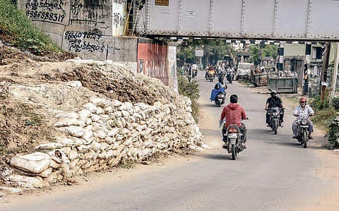 A temporary bund set up to facilitate execution of railway track works at Devi Nagar railway bridge in Vijayawada; infrastructure issues and bad roads plague roads; incomplete walking track upsets residents| R V K Rao