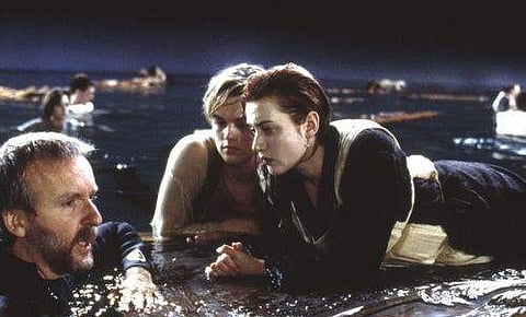 James Cameron with Leonardo Dicaprio and Kate Winslet in the famous ending scene set | Fanpop.com