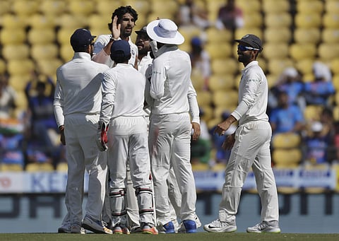 India's Ishant Sharma, center without cap, celebrates with teammates the dismissal of Sri Lanka's Niroshan Dickwella during the fourth day of their second Test match in Nagpur, India, Monday, Nov. 27, 2017. | AP
