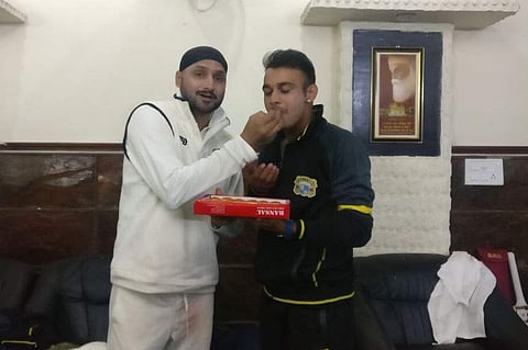 Punjab captain Harbhajan Singh shares sweets with Siddharth Kaul. (Twitter/ Harbhajan Turbanator)