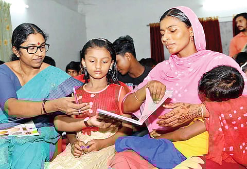 A file photo of P S Sreekala, director of Kerala State Literary Mission Authority, conducting a class for migrant labourers on Thursday | Express