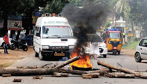 Anti-GAIL protestors set fire to tyres put up by the police as barricade at Eranjimav Mukkam Arecode Road in Kozhikode on Thursday | A Sanesh