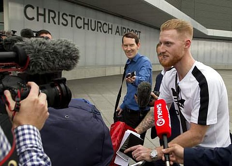 New Zealand-born England cricket star Ben Stokes, right, is surrounded by media as he arrives in Christchurch, New Zealand.| AP
