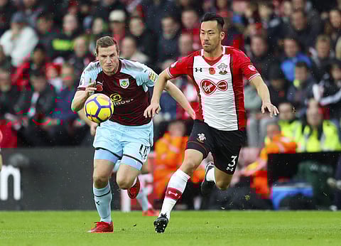 Burnley's Chris Wood, left, and Southampton's Maya Yoshida chase the ball during their English Premier League soccer match at St Mary's Stadium in Southampton, England, Saturday Nov. 4, 2017. | AP