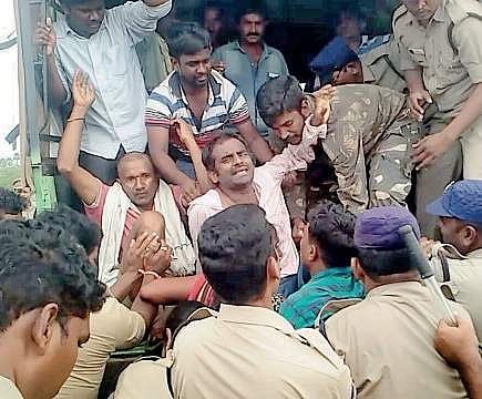 Police bundling farmers into vehicles at Ramanakkapeta village in Uppada Kothapalli mandal on Saturday | Express