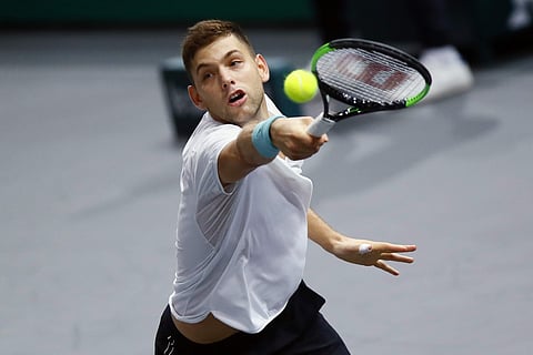 Filip Krajinovic of Serbia returns the ball to John Isner of the United States during their semi-final match | AP