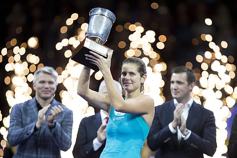 Julia Goerges of Germany poses with the trophy after defeating Daria Kasatkina of Russia and winning the final match at the Kremlin Cup tennis tournament in Moscow, Russia, Saturday, Oct. 21, 2017. | AP