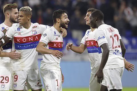 Lyon's Nabil Fekir, center, celebrates with his teammates after he scored a goal against Monaco during their French League One soccer match in Decines, near Lyon, central France, Friday, Oct. 13, 2017. | AP