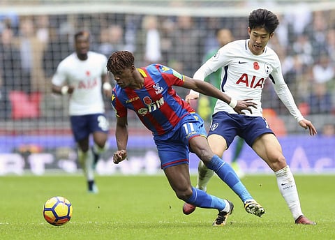 Crystal Palace's Wilfried Zaha, left and Tottenham Hotspur's Son Heung-Min battle for the ball, during the English Premier League soccer match between Tottenham Hotspur and Crystal Palace, at Wembley Stadium. | AP
