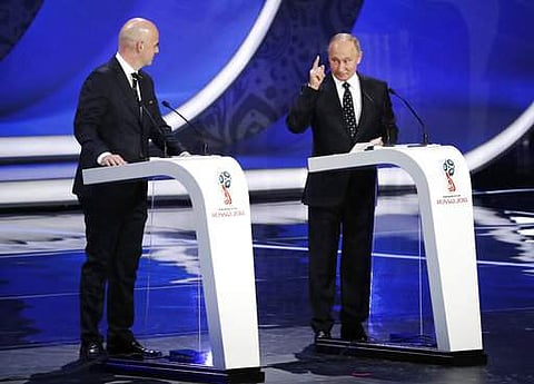 Russian President Vladimir Putin, right, is watched by FIFA president Gianni Infantino as he speaks before the 2018 soccer World Cup draw in the Kremlin in Moscow.|AP