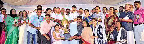 Power Minister  M M Mani handing over the trophy for overall champion to the Aluva sub-district team