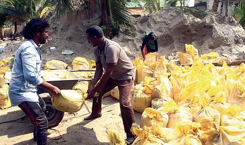 DYFI activists removing sand deposited by sea in the effect of cyclone Ockhi near  Maruvakadu Velankanni Church in Kochi on Sunday |Melton Antony
