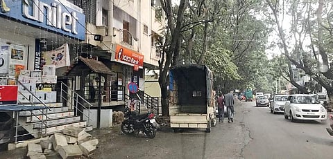 Shops are built on footpaths and people park their delivery vehicles on the road