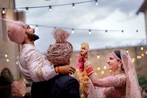 Indian cricket captain Virat Kohli with his actress wife Anushka Sharma during their wedding in Milan Italy on Monday. | PTI