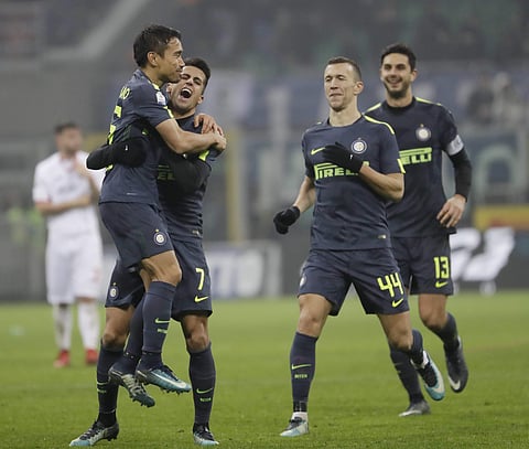 Inter Milan's Yuto Nagatomo celebrates with teammates Joao Cancelo, Ivan Perisic and Andrea Ranocchia after scoring the decisive penalty | AP