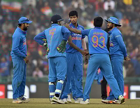 India's Washington Sundar celebrates with teammate the dismissal of Sri Lanka's Lahiru Thirimanne during the second one-day international cricket match in Mohali. | PTI