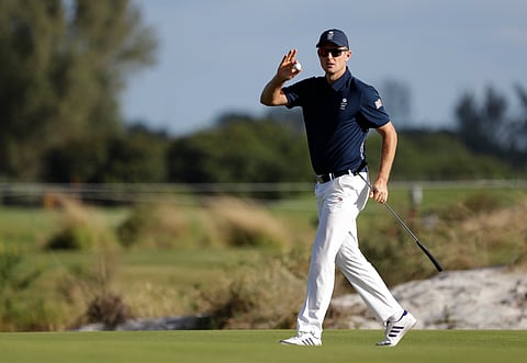 Justin Rose, of Great Britain, holds his ball after putting out on the 18th hole during the first round of the men's golf event at the 2016 Summer Olympics in Rio de Janeiro, Brazil, Thursday, Aug. 11, 2016. | AP
